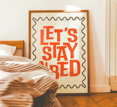 Let's Stay In Bed typography wall art for bedroom decor in warm retro colors