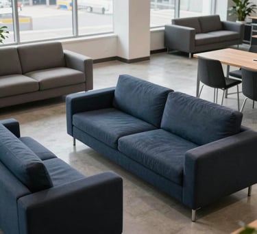 A high-angle photo of a modern office lounge area in a logistics company, featuring navy and slate furniture, clean lines, and natural lighting, North American / US.