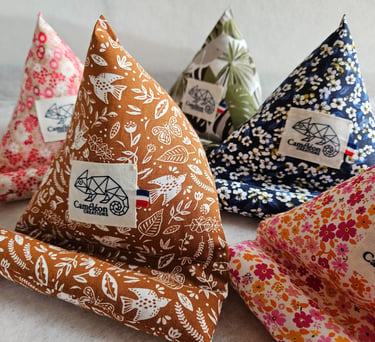 Handmade fabric pyramid phone stands in various floral and botanical patterns by Cameleon Creations.