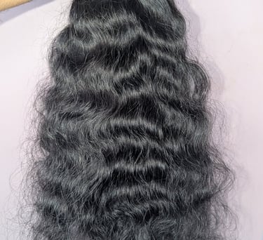 Wavy raw human hair bundles from Tanori Hair LLP prepared for wholesale export