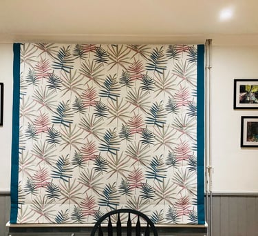 Picture of roman blind that is down that has borders both sides to emphasise one of the colours in the main fabric