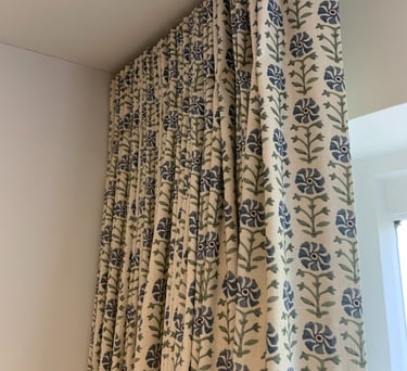 Bespoke curtains with single pleat heading hanging on a neat curved ceiling track supplied by me