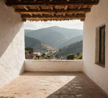 Photography of a wide, open-air terrace with white-washed walls and a thatched roof, overlooking a mountain valley, Latin American / Spanish architecture, morning light, palette of cream and tan.