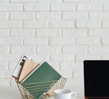a laptop computer sitting on a desk with a cup of coffee