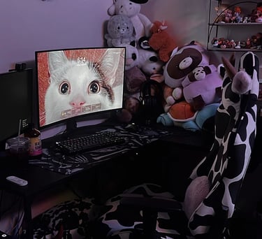 a computer desk with a computer monitor and a cat