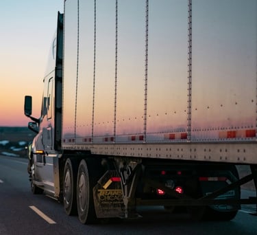 Trucking image representing driver misclassification, unpaid wages, miles, and detention pay cases