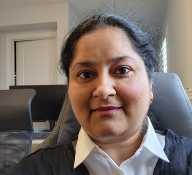 a woman in a chair with a white shirt and a black sweater