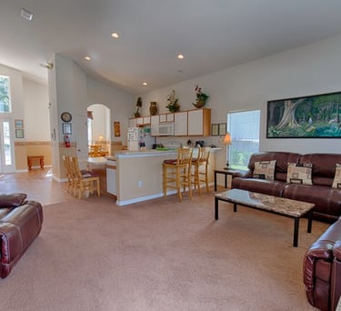 a living room with a couch and a table in open plan villa in Florida