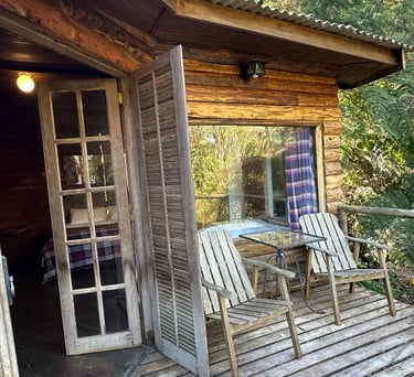 a wooden deck with a table and chairs
