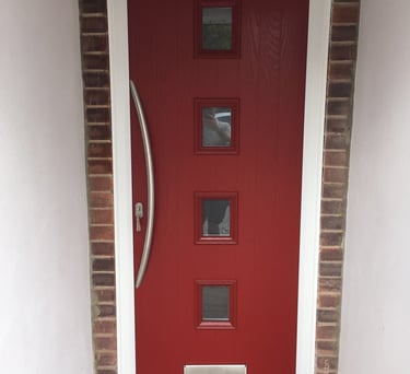 a new red composite front door with 4 squares of glass and curved long handle