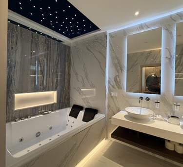 a bathroom with a tub tub and a large mirror