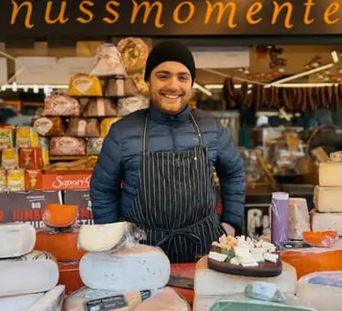 Local vendor showcasing authentic Austrian cheeses at a traditional market.