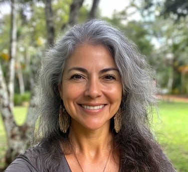 Mujer con cabello canoso usando aretes largos  en un parque tomándose una selfie 