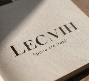 Macro photography of an elegant Spanish-speaking editorial magazine, focus on minimalist typography on heavy paper stock, warm stone tones, soft shadows.