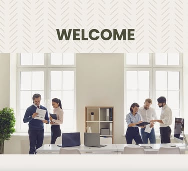a group of people standing around a desk with a welcome sign