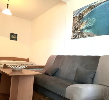 a couch with a bowl of fruit on it