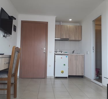 a kitchen with a refrigerator, microwave, and a refrigerator