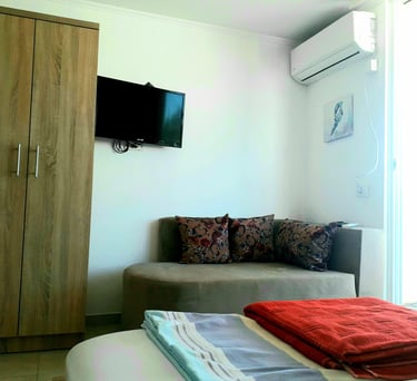 a couch with a television mounted on the wall