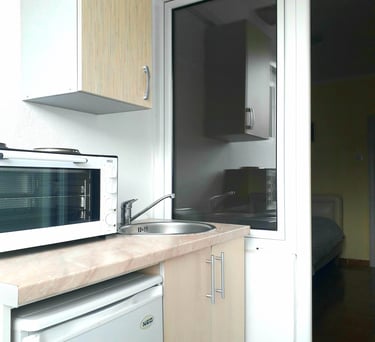 a couch with pillows and a table with a tv