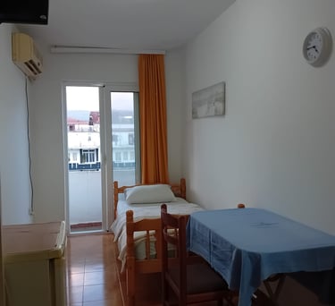 a small room with a bed and a table