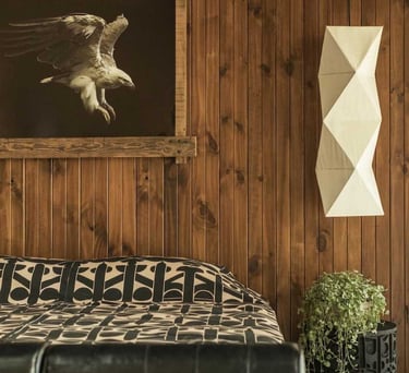 a bed with a large picture of a bird in the background
