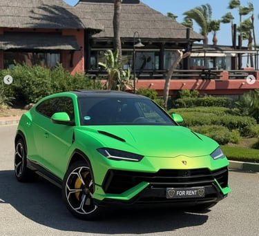 A lime green Lamborghini Urus luxury rental car parked outside a tropical resort.