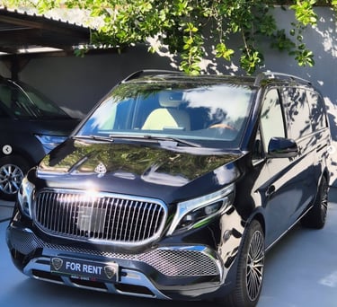 Luxury black Mercedes-Benz V-Class passenger van for rent with chrome grille and premium alloy wheels.