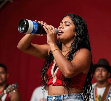 A South American / Brazilian Amazonian candid shot of a lead singer pouring her heart out during a live regional festival in Santa Bárbara do Pará. Warm spotlight illumination, vivid background colors of deep carmine red.