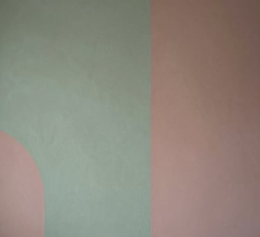A detail of a wall with minimalist artwork in sage green and dusty rose tones, elegant Southern European / Italian interior design.