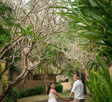 Intimate couple walking through lush tropical garden at Waka Gangga Tabanan