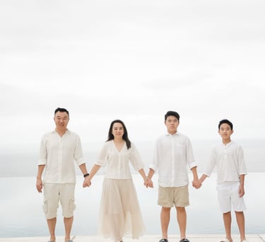 Family standing in minimal ocean view composition at Alila Villas Uluwatu Bali with clean horizon