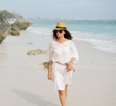 Mother walking alone along the beach at Karma Kandara Bali  