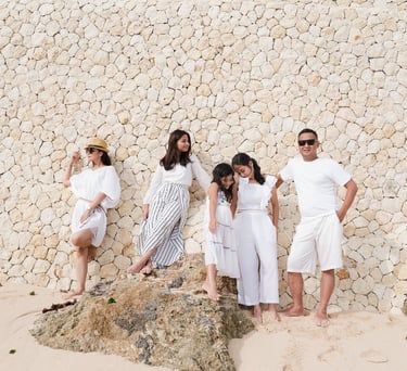 Extended family portrait on the beach with cliff backdrop at Karma Kandara Bali  