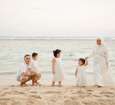 Quiet family moment by the shoreline during Ilham family photography session at Melasti Beach Bali