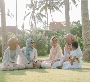 Friends sitting and talking on lawn during photoshoot at Candi Beach Resort Karangasem Bali