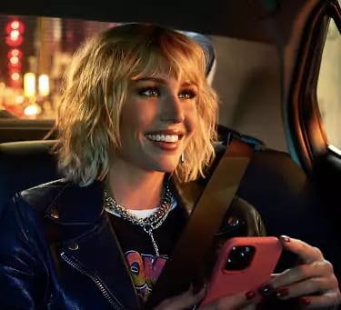 a woman in a leather jacket and a cell phone