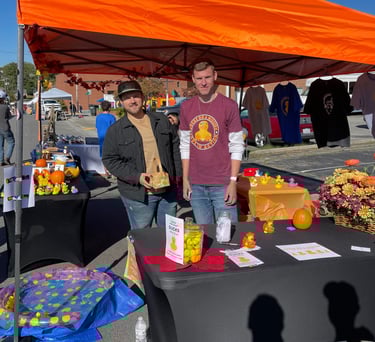 two men standing in front of a table with a table with a table cloth