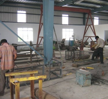 a man working on a machine in a factory