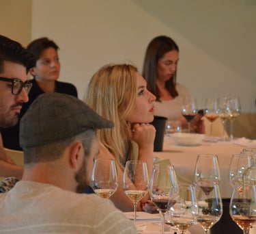 Group of buyers sitting at a table with glasses of wine in front of them