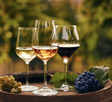 3 glasses of wine on a wine barrel
