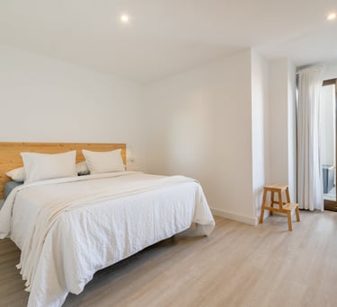 a bedroom with a bed queen size and a wooden headboard