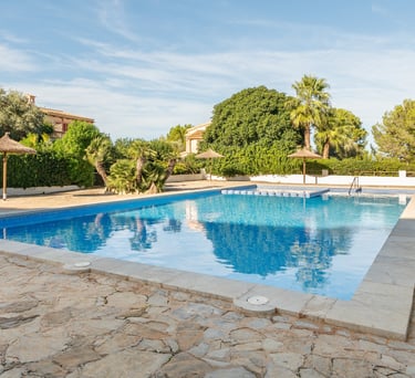 a pool with a umbrellas and hammocks 