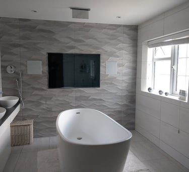 Professional installation of a flush-mounted waterproof bathroom TV in a luxury London