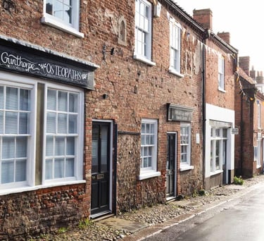 a street scene with a brick building and a sign that says,'the sign