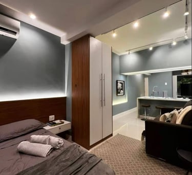 a bedroom with a bed, couch, and a couch
