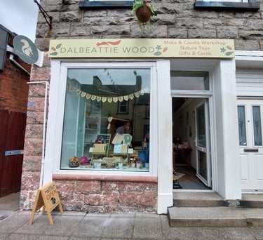 Dalbeattie Wood shop front showing shop window open door and shop sign above with squirrel logos