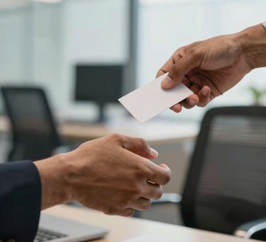 A detailed shot of hands exchanging a business card or shaking hands in a bright, modern Indian office environment.