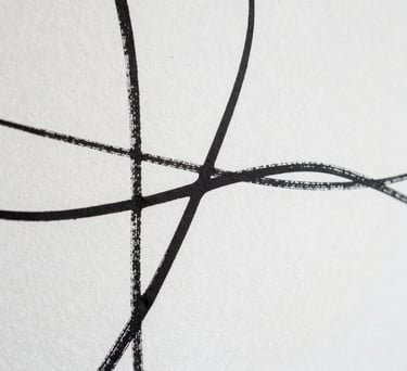 Detail of a white wall with an abstract, minimalist ink drawing. High contrast, elegant editorial style, artistic composition.