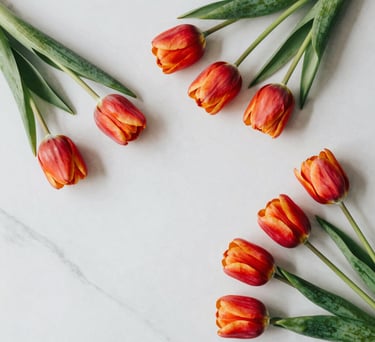 A top-down view of vibrant spring tulips on a white smoke marble surface, clean lines and natural soft lighting, modern North American interior aesthetic.