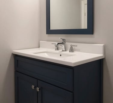 Interior view of an accessible bathroom in a North American home, featuring high-quality fixtures, deep charcoal navy accents, and clean design.